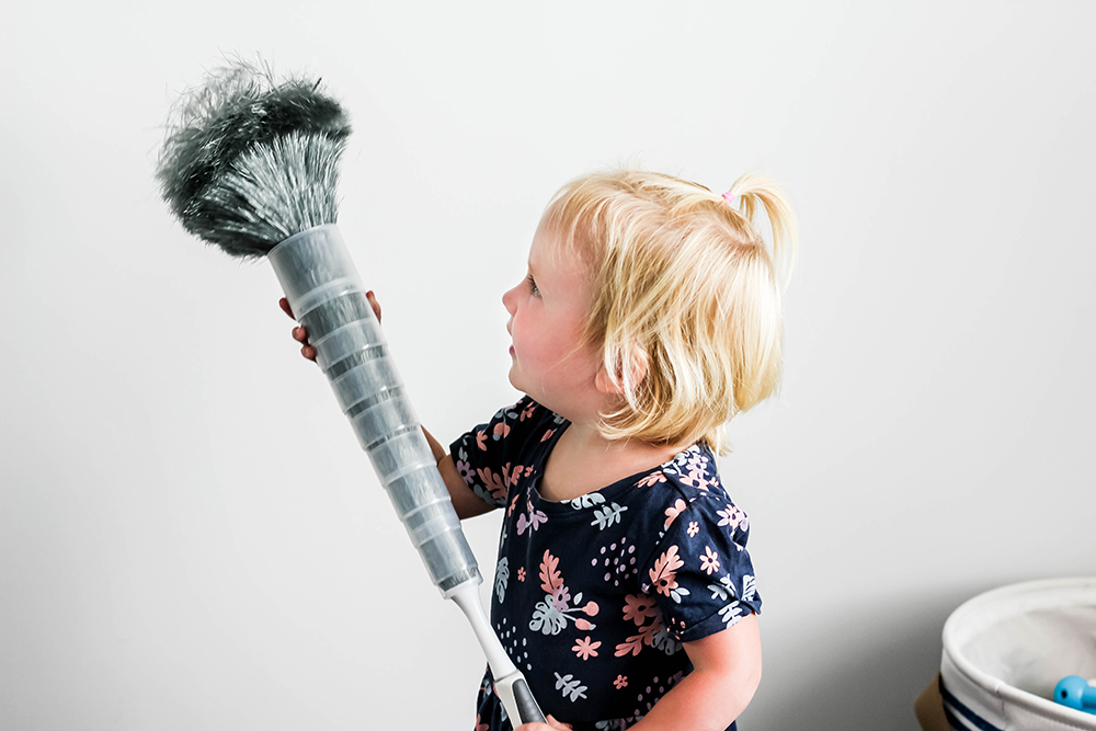 Toddler girl dusting